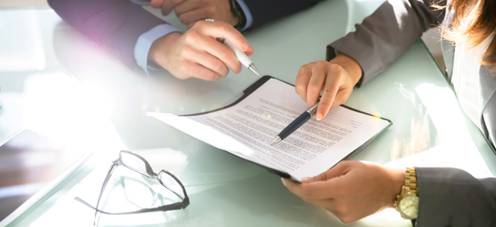 Stock image of two people going over a contract.