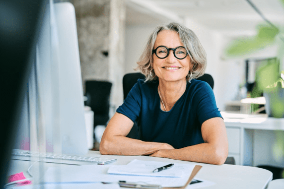 Stock photo of a smiling employee with grey hair.
