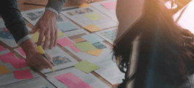 Stock image of sticky notes being organized on a board.