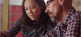 Stock photo of two people looking over their finances.