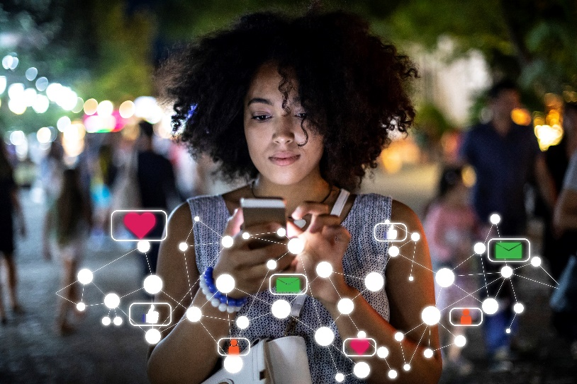 Stock image of a person on a phone that is connected to other people.